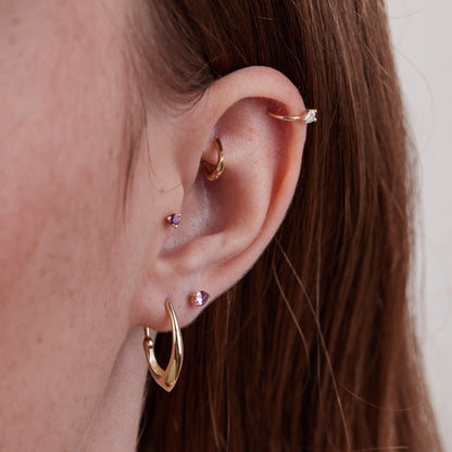 Triangle piercing with a round stone