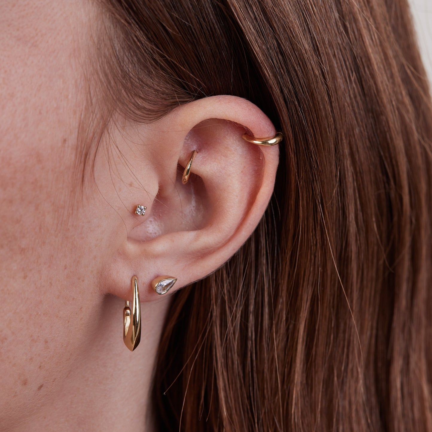 Piercing with a drop stone in a gold frame