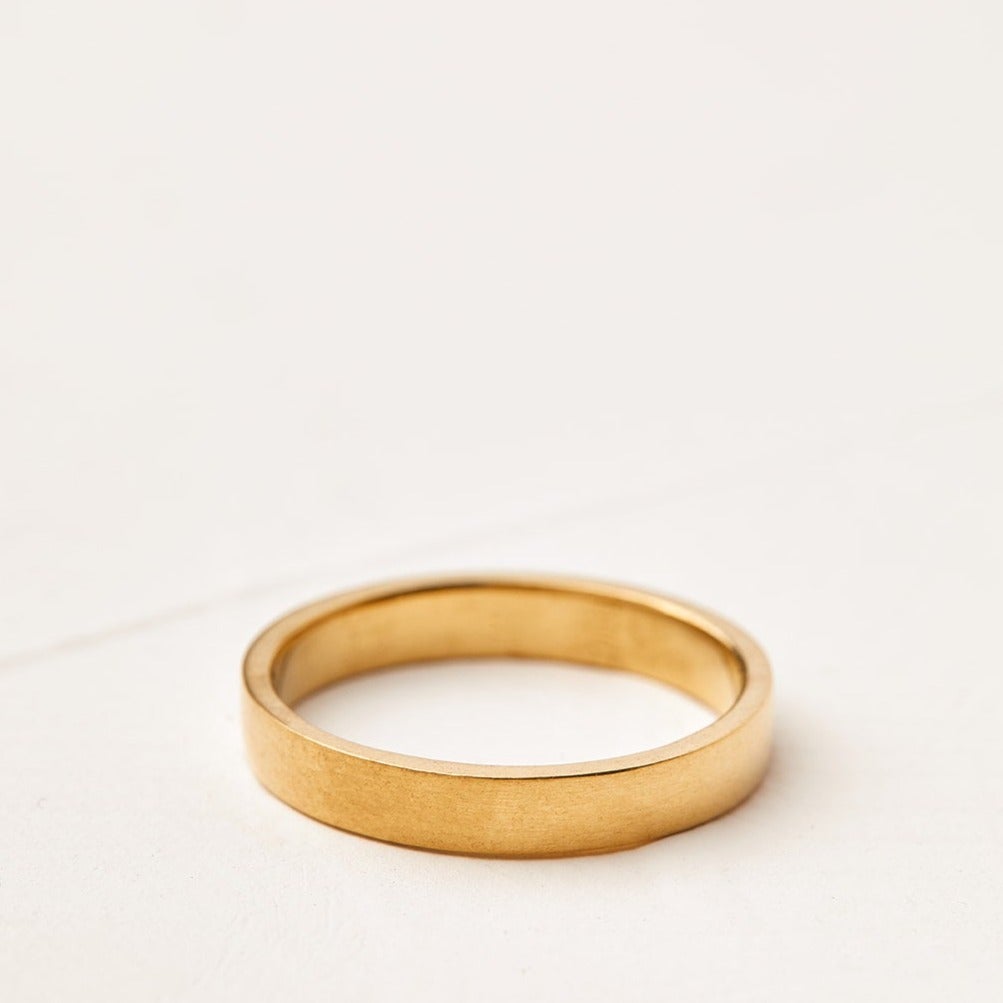 A gold wedding ring for a man, a thick oak model