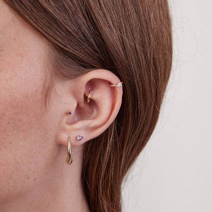 Small gold hoop piercing