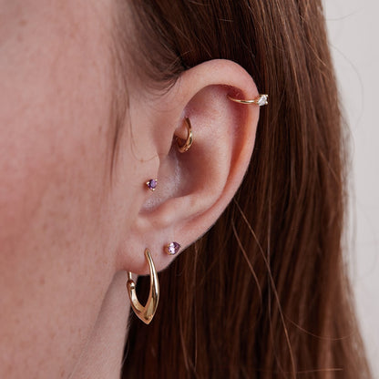 Small gold hoop piercing