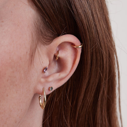 Small gold hoop piercing